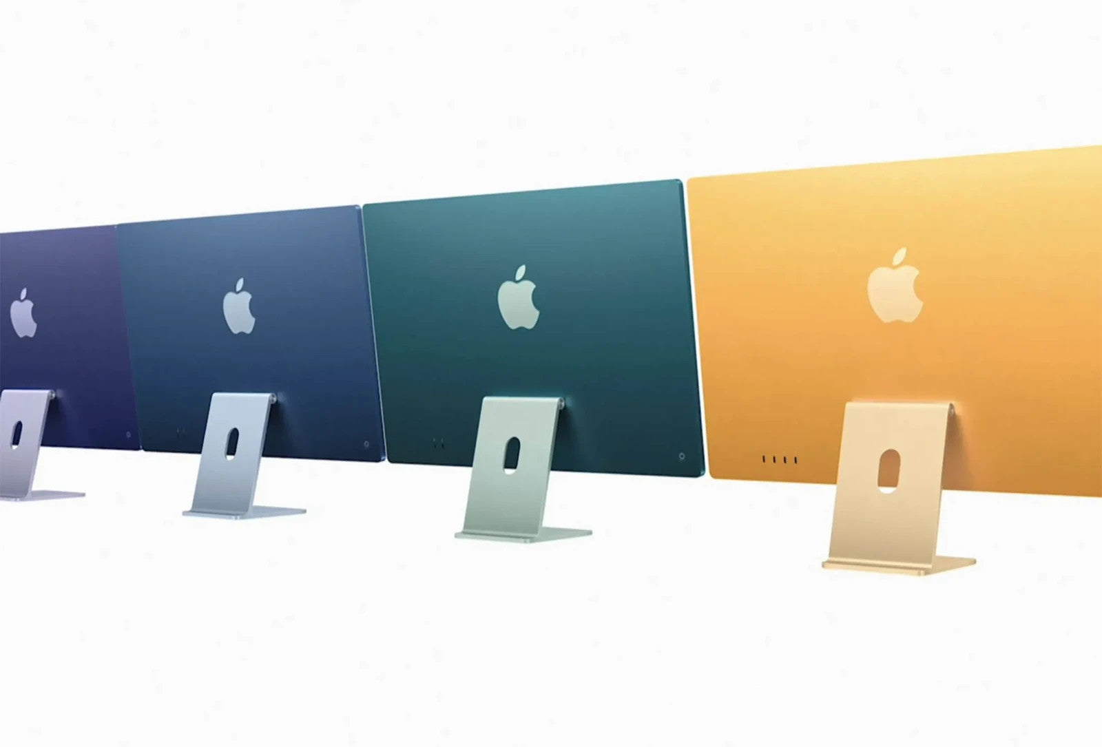 Four Apple iMac 2021 models in purple, blue, green, and yellow colors shown from the back on white background