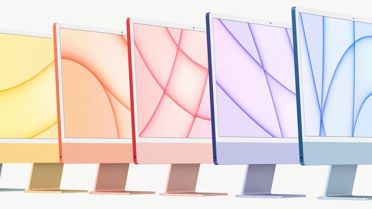 Five Apple iMac 24-inch models in yellow, orange, pink, purple, and blue colors lined up side by side on white background