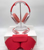 Apple AirPods Max Lightning model A2096 over-ear headphones in pink with cushioned ear cups and matching red carrying case displayed.