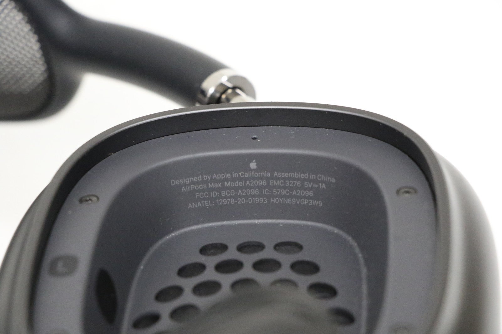 Close-up view of the inside ear cup of Apple AirPods Max Space Gray wireless over-ear headset showing model details.