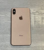 Apple iPhone XS Max in gold color showing the back with dual camera and Apple logo on wooden surface