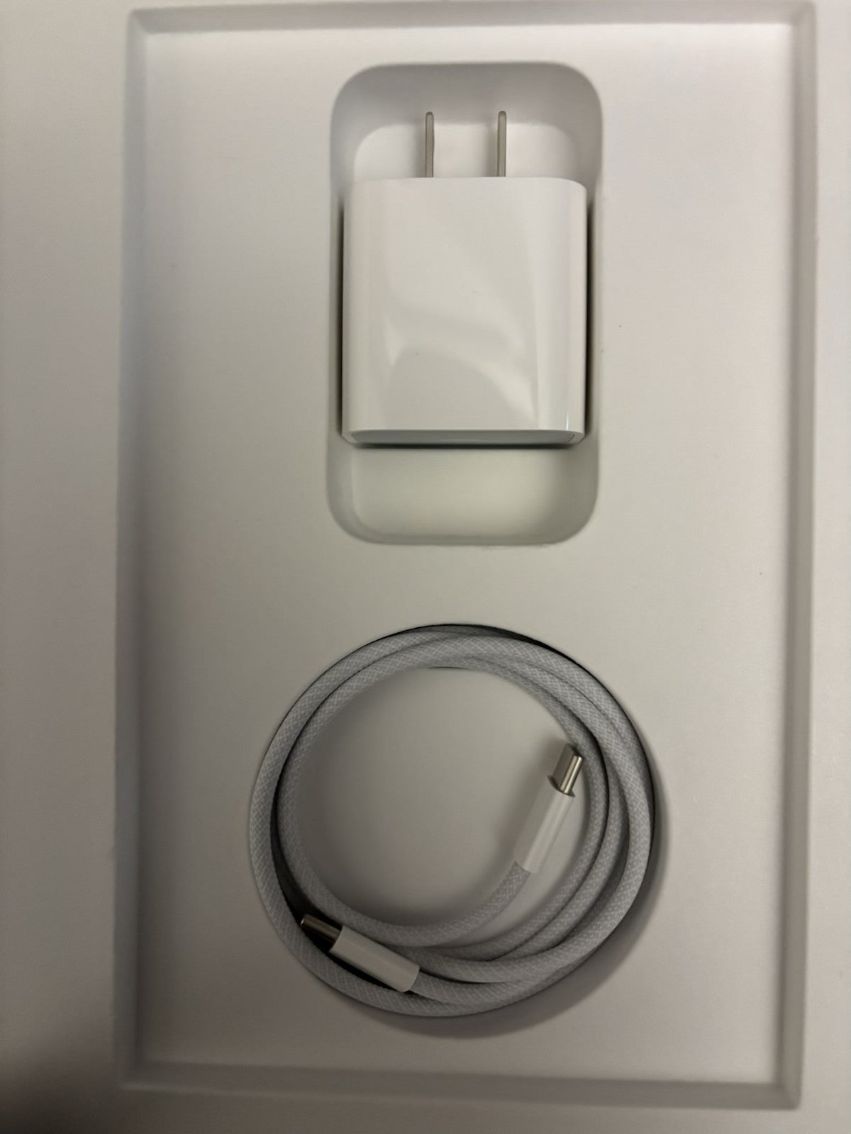 Apple iPad 10th Gen charger and braided USB-C charging cable neatly packed in white box insert