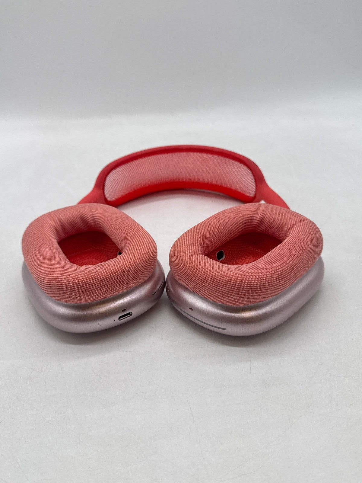 Apple AirPods Max Lightning model A2096 in pink with over-ear cushioned ear cups and headband shown front side up