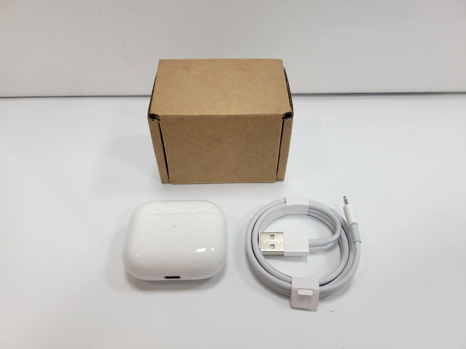 Apple AirPods 3rd Generation wireless in-ear headset white with charging case, USB-C to Lightning cable, and plain brown box
