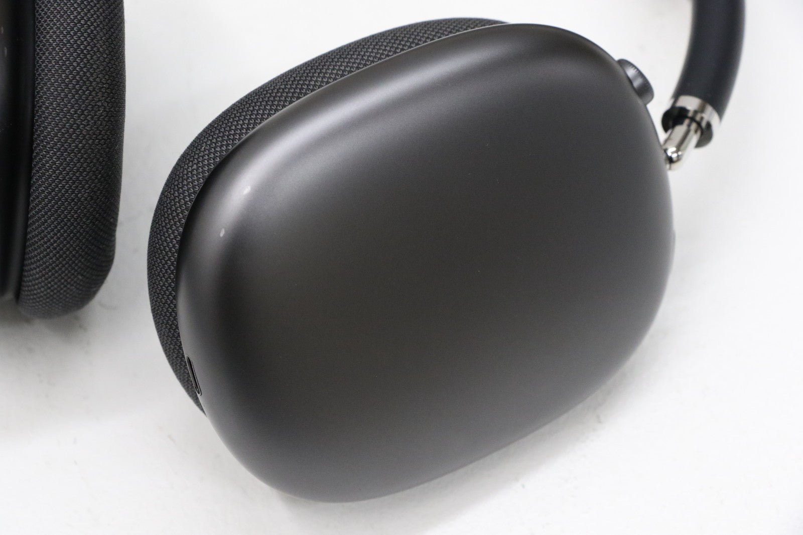 Apple AirPods Max wireless over-ear headset in space gray, close-up of ear cup and mesh cushion details