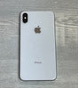Apple iPhone XS Max in silver showing back with dual camera and Apple logo on wooden surface background