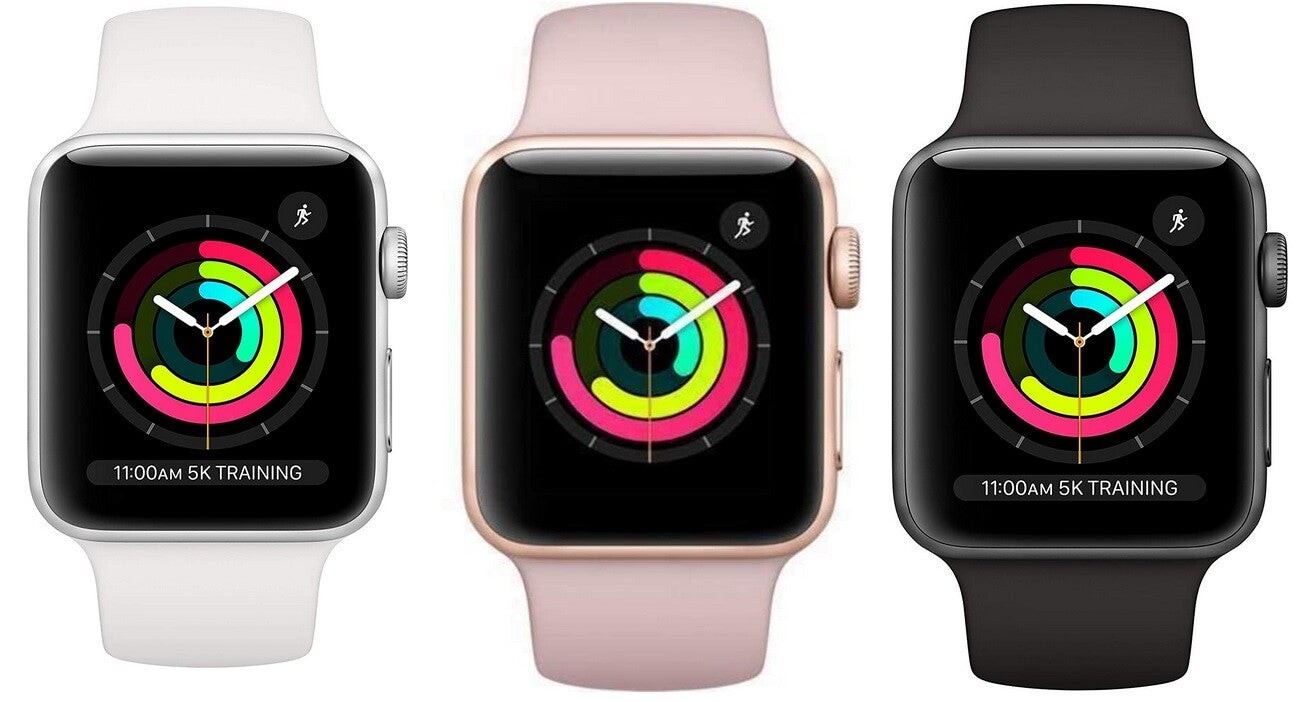 Three Apple Watch Series 3 models in white, rose gold, and black with activity rings and silicone bands displayed front view