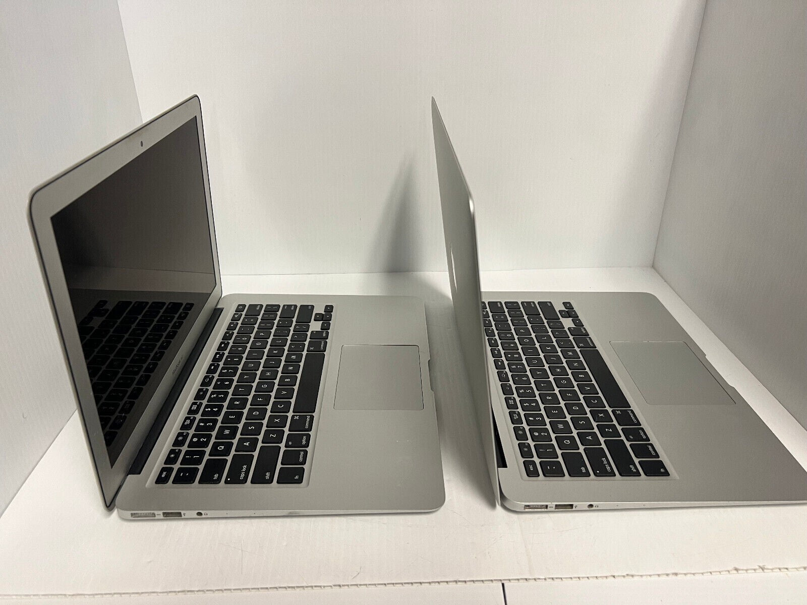 Apple MacBook Air A1466 13.3-inch open side-by-side showing keyboard and screen in silver finish
