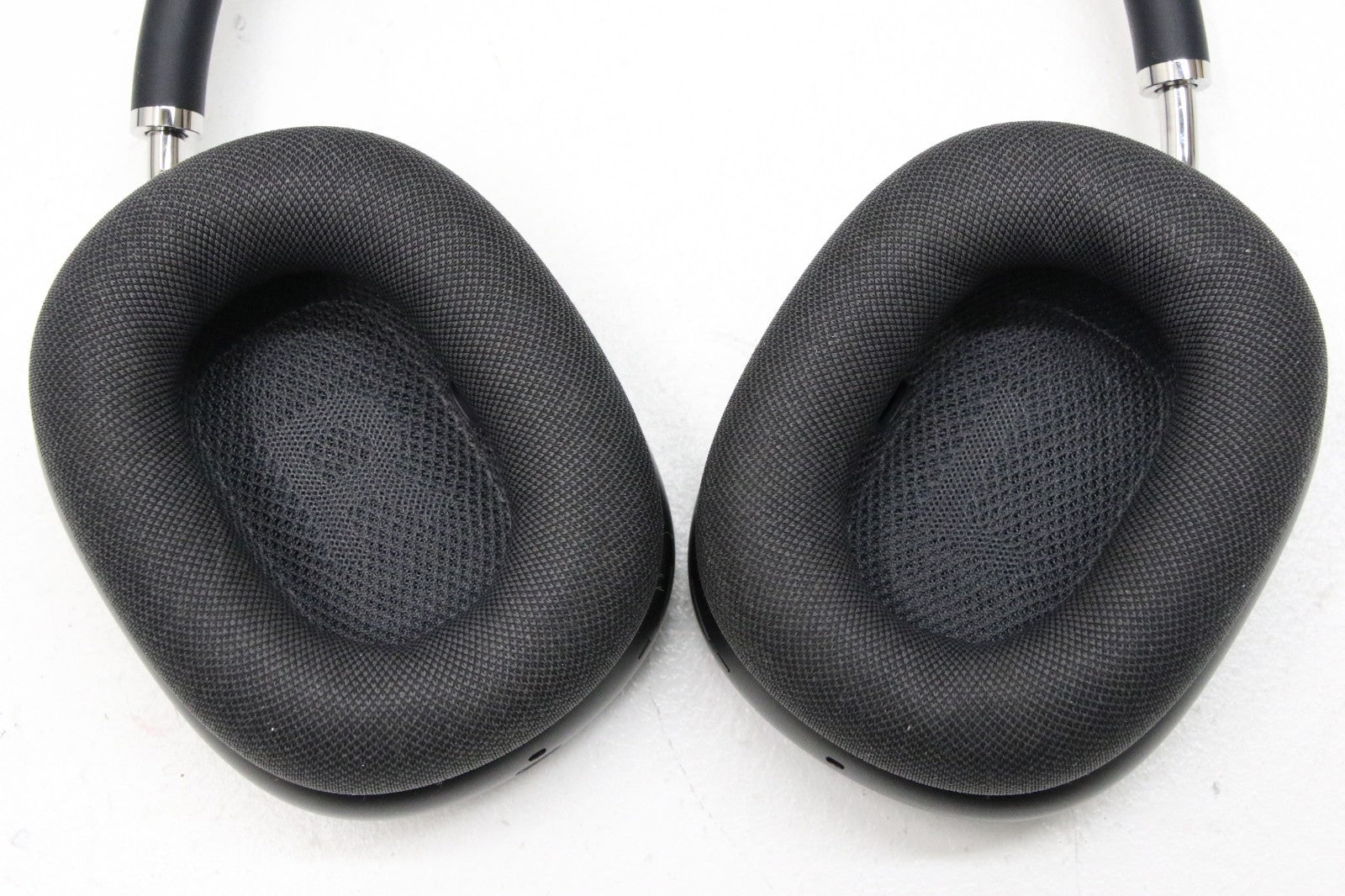 Close-up of Apple AirPods Max Space Gray ear cups showing breathable mesh cushioning and over-ear design