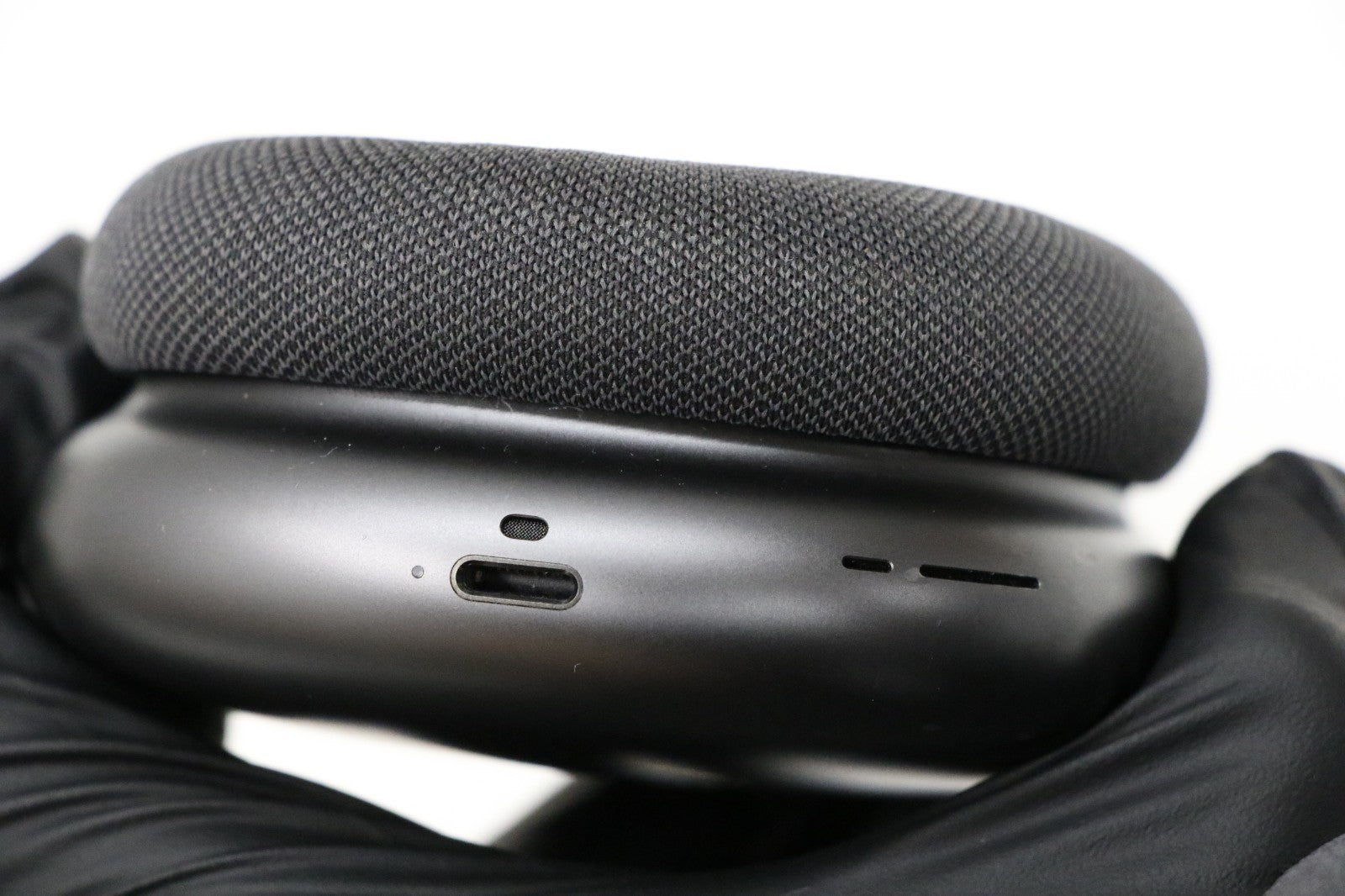 Apple AirPods Max Wireless Over-Ear Headset in Space Gray showing close-up of charging port and mesh ear cushion