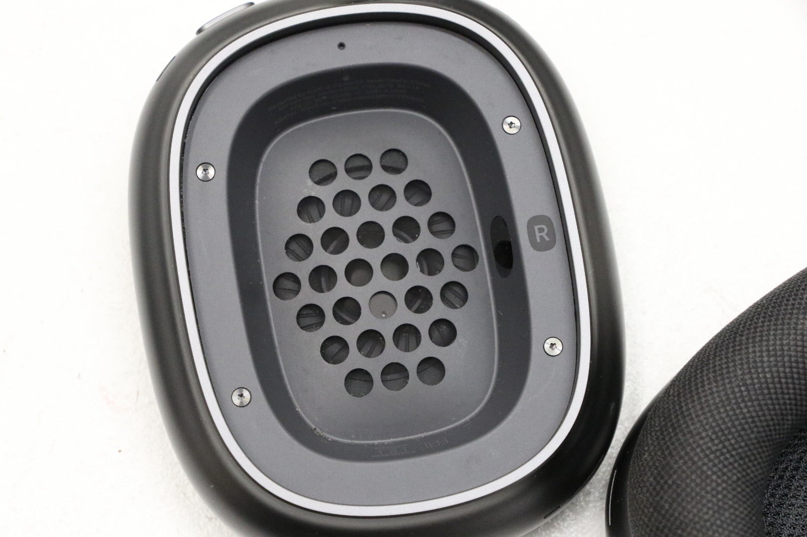 Apple AirPods Max wireless over-ear headset right earcup showing mesh speaker grille in space gray color
