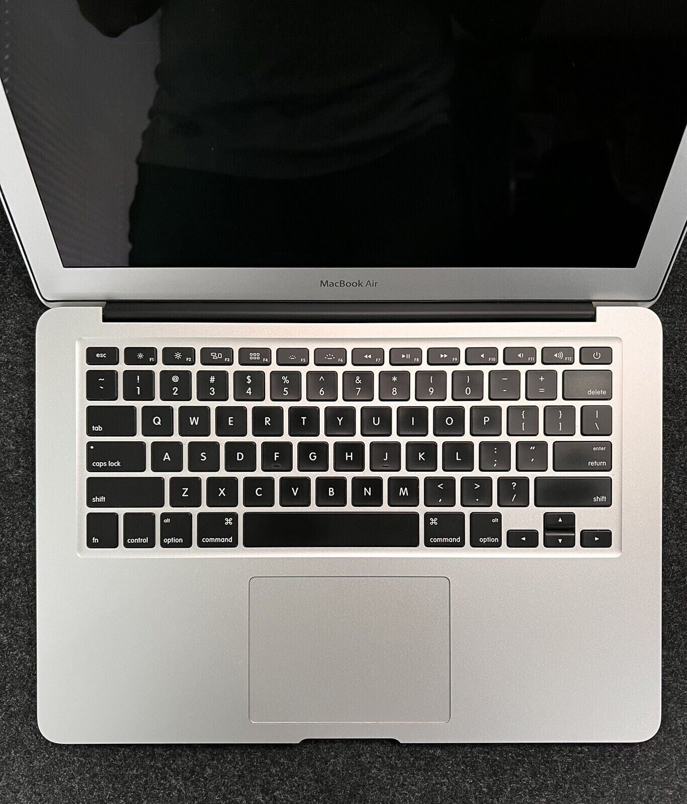 Apple MacBook Air A1466 open top view showing keyboard, trackpad, and part of 13.3-inch screen in silver color