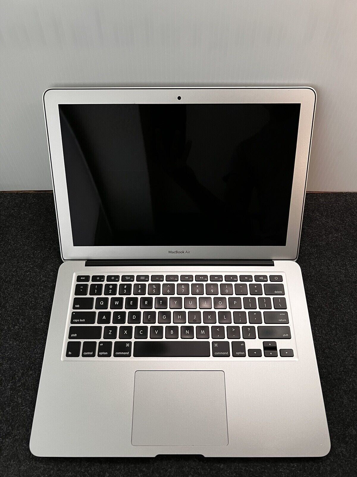 Apple MacBook Air A1466 13.3-inch open screen showing keyboard and trackpad in silver finish, Intel Core i5 model