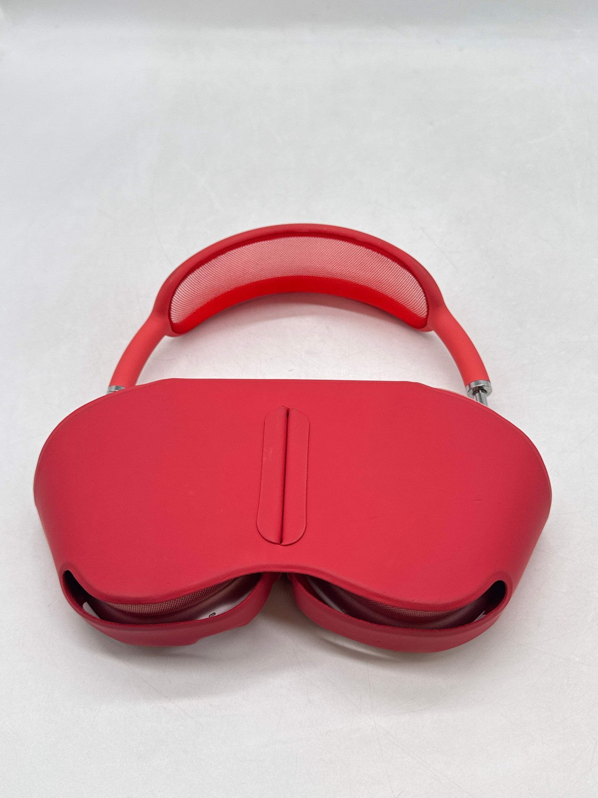 Red Apple AirPods Max A2096 over-ear headphones with cushioned headband and mesh padding, shown folded flat top view
