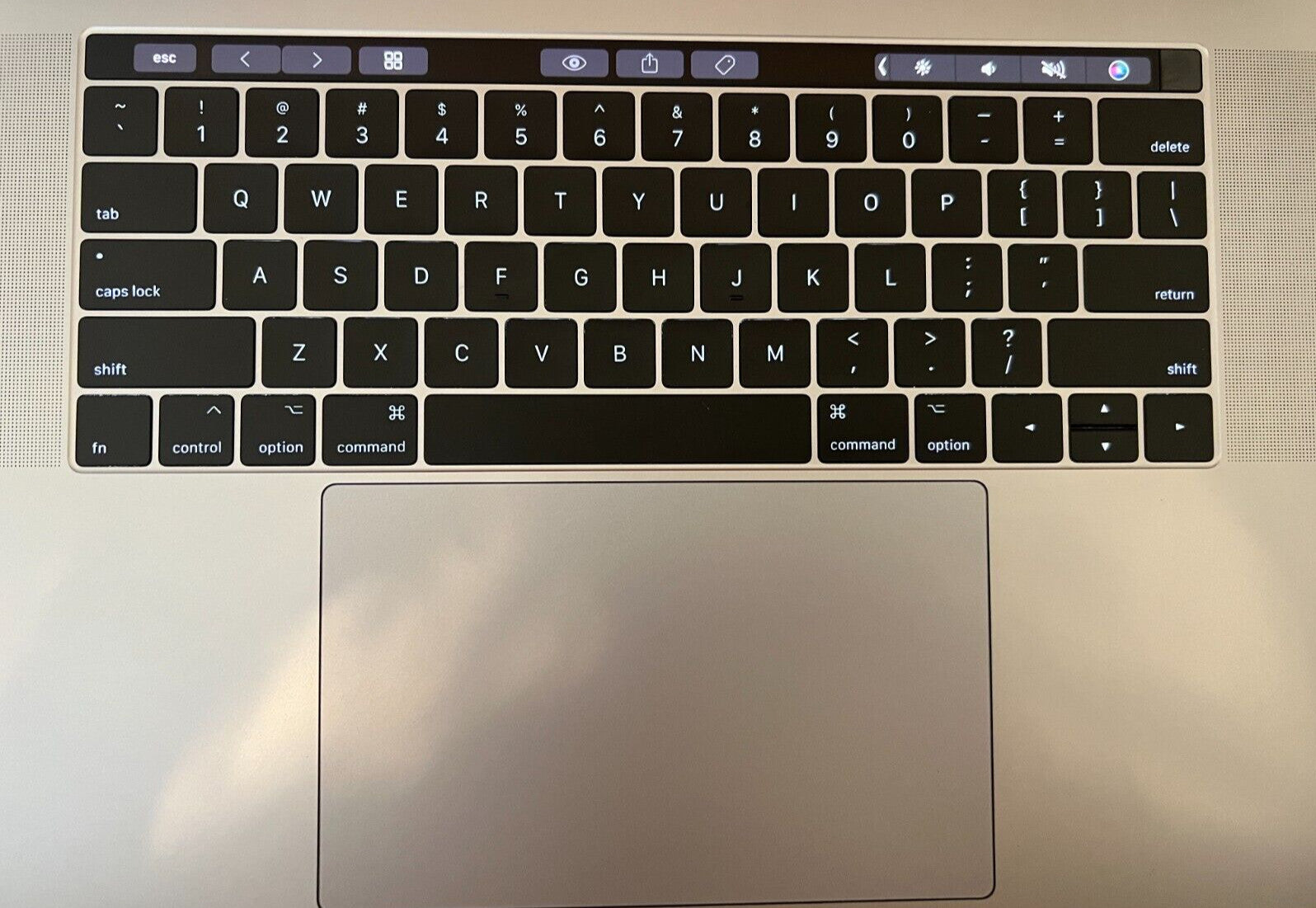 Apple MacBook Pro 15-inch keyboard and Touch Bar in silver with large trackpad and backlit keys, excellent condition