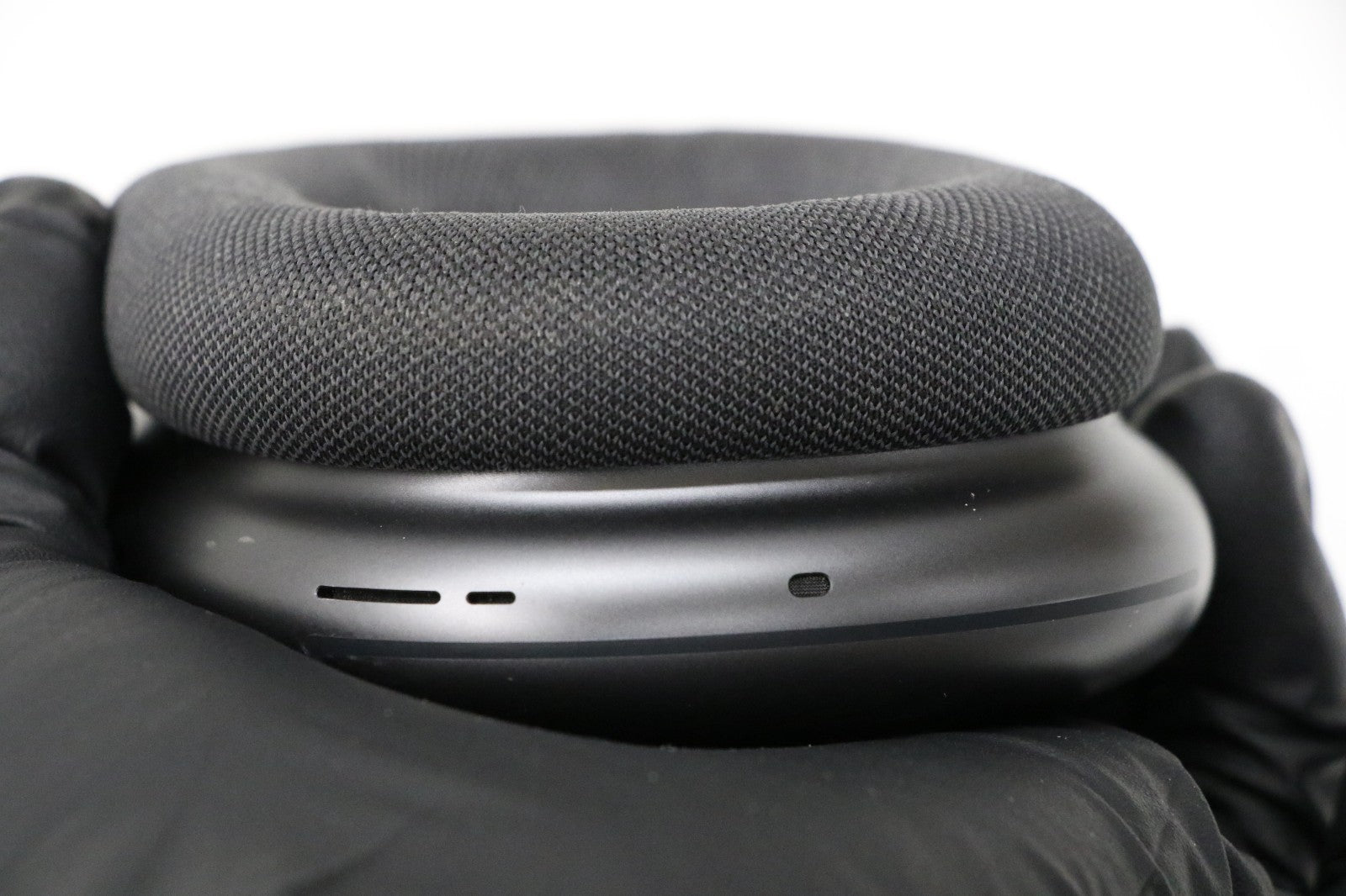 Close-up of Apple AirPods Max Space Gray wireless over-ear headset showing ear cushion and stainless steel frame detail