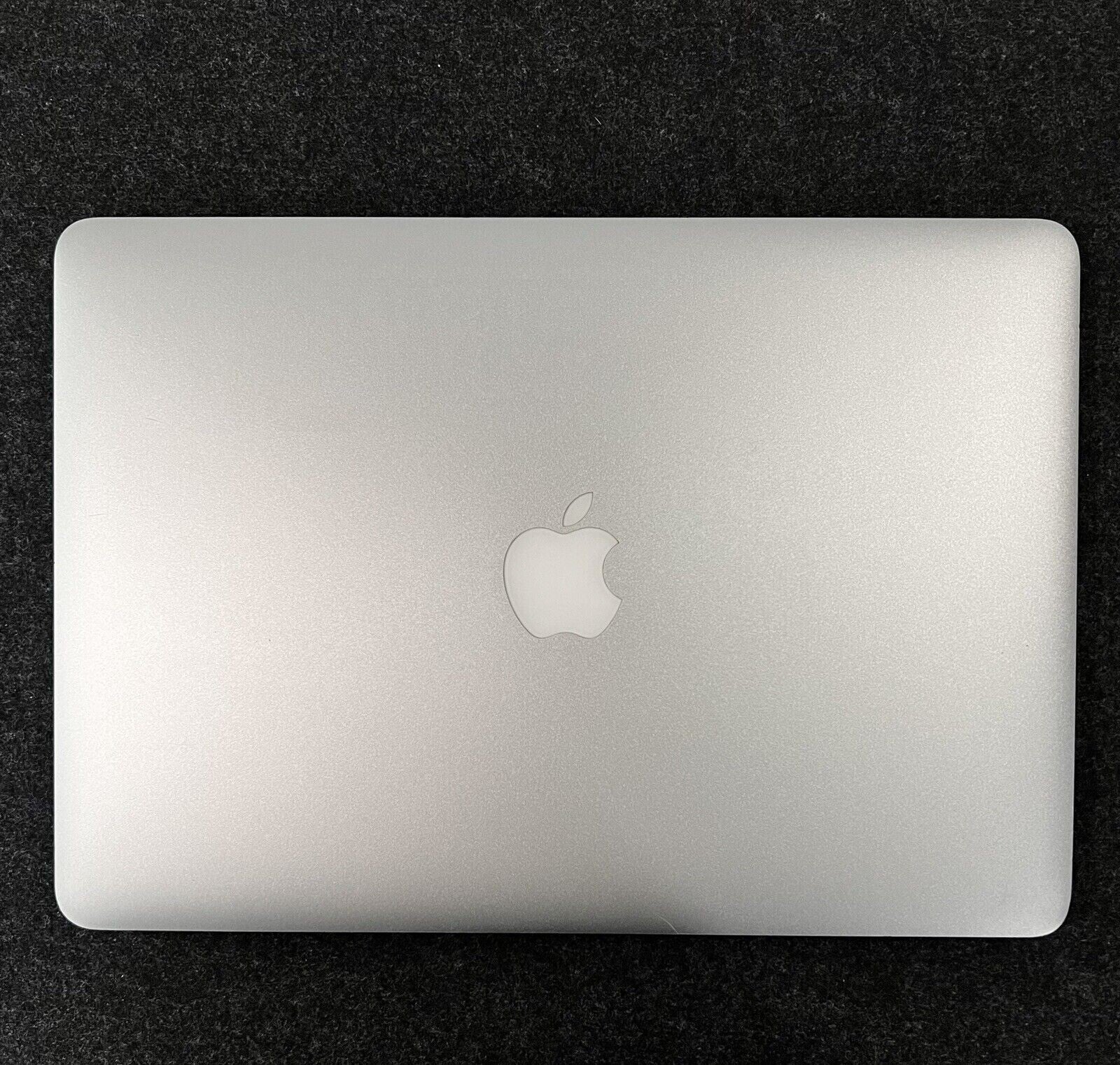 Apple MacBook Air A1466 13.3-inch laptop closed showing silver aluminum top with Apple logo centered on dark background