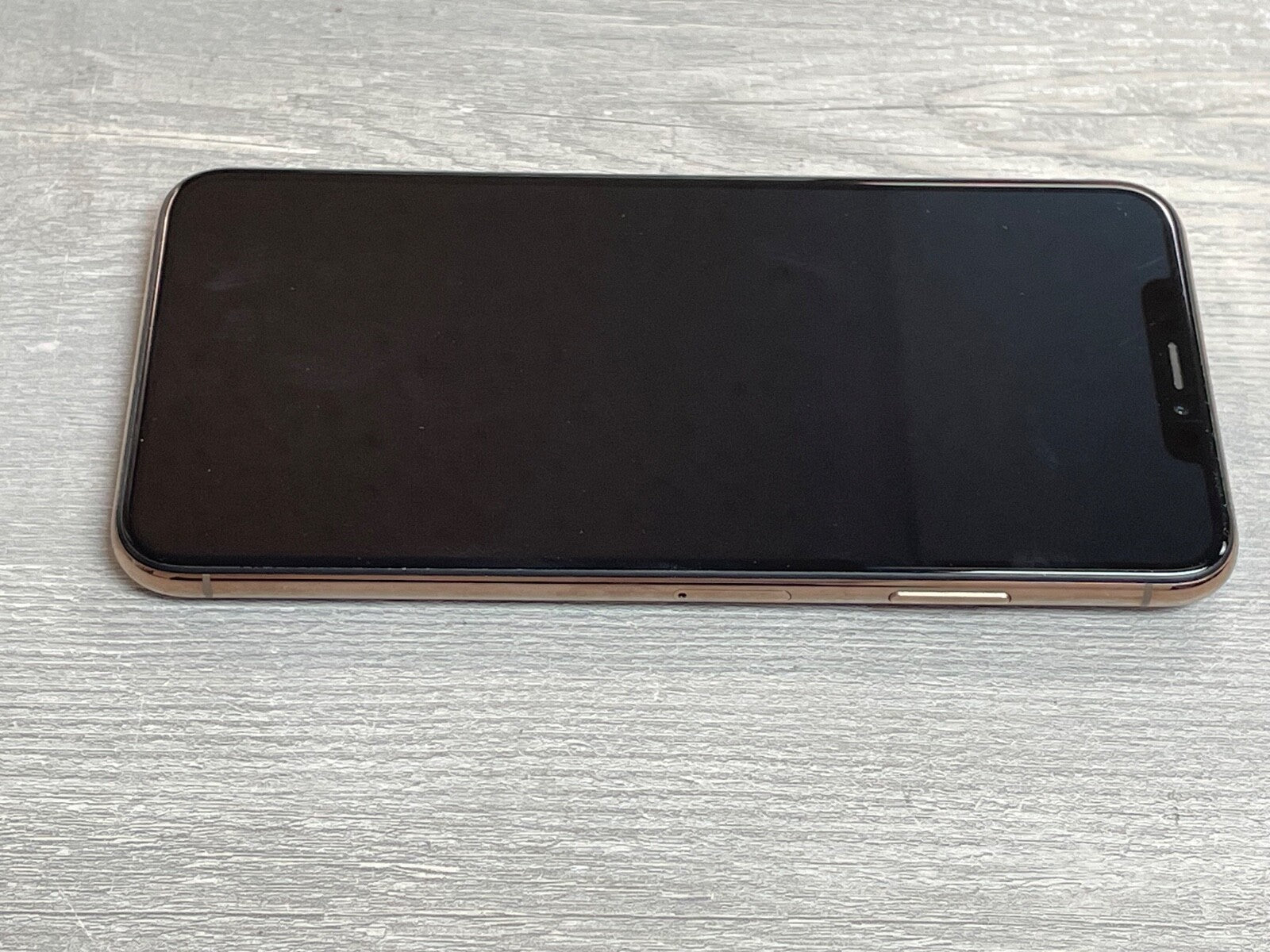 Apple iPhone XS Max with 6.5-inch screen, side view showing power and volume buttons, factory unlocked model A2101.