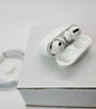 Apple AirPods Pro with wireless charging case open on white box with charging cable nearby in very good condition