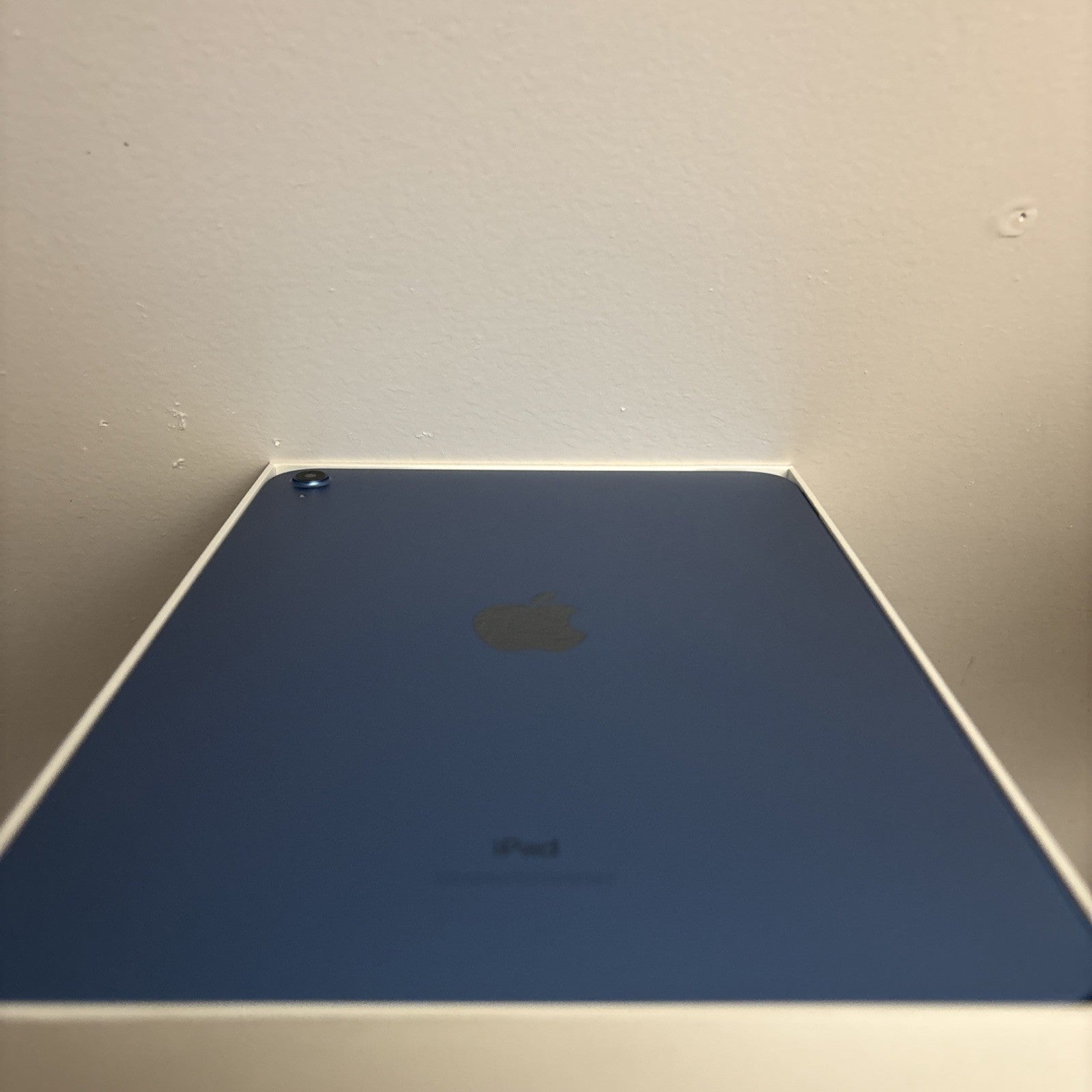 Blue Apple iPad 10th Gen 10.9-inch showing back with single camera and Apple logo, excellent condition packaging