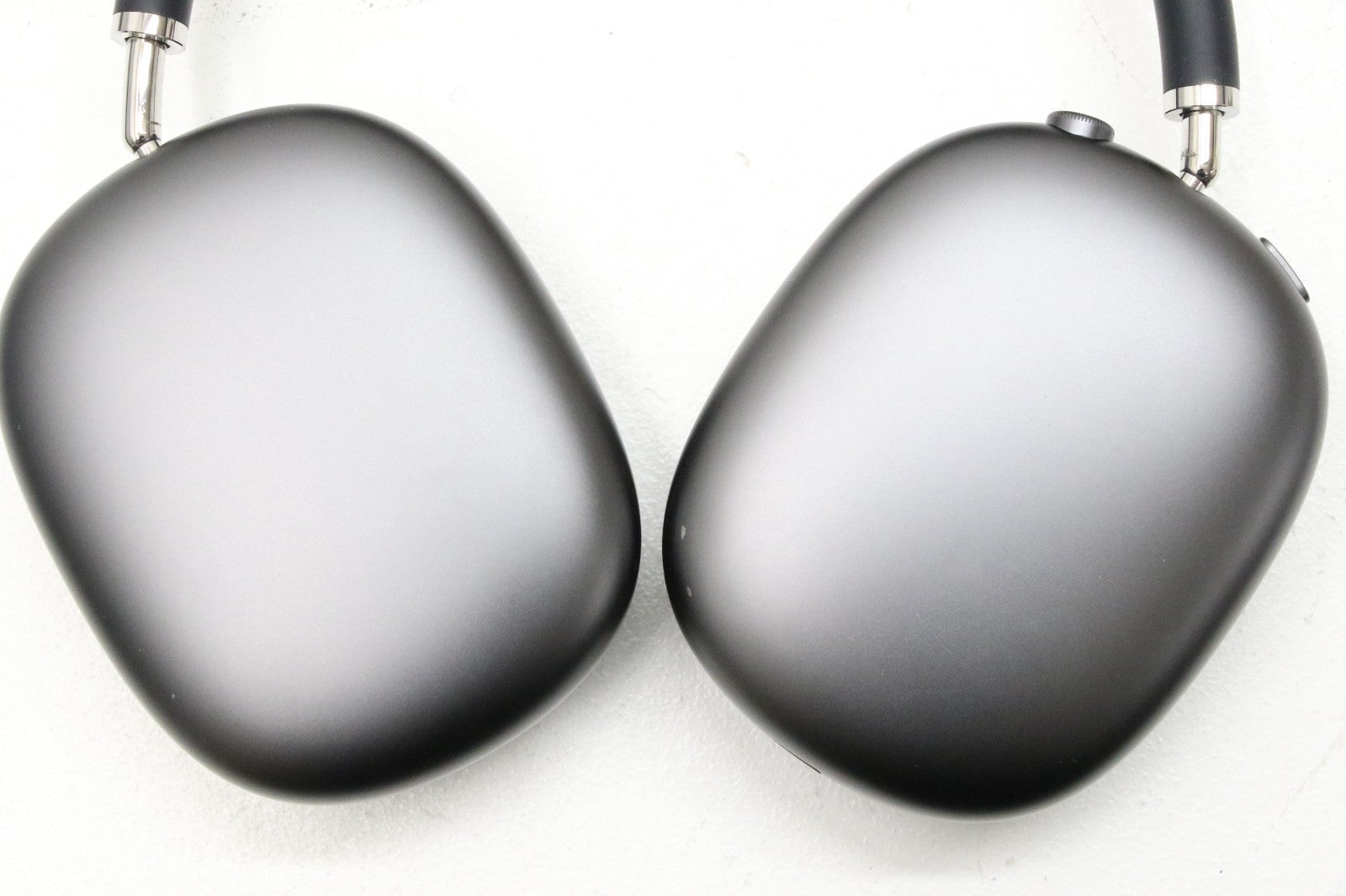 Apple AirPods Max wireless over-ear headphones in space gray showing ear cups and stainless steel frame details