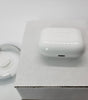 White Apple AirPods Pro wireless charging case and charging cable on white box, very good condition