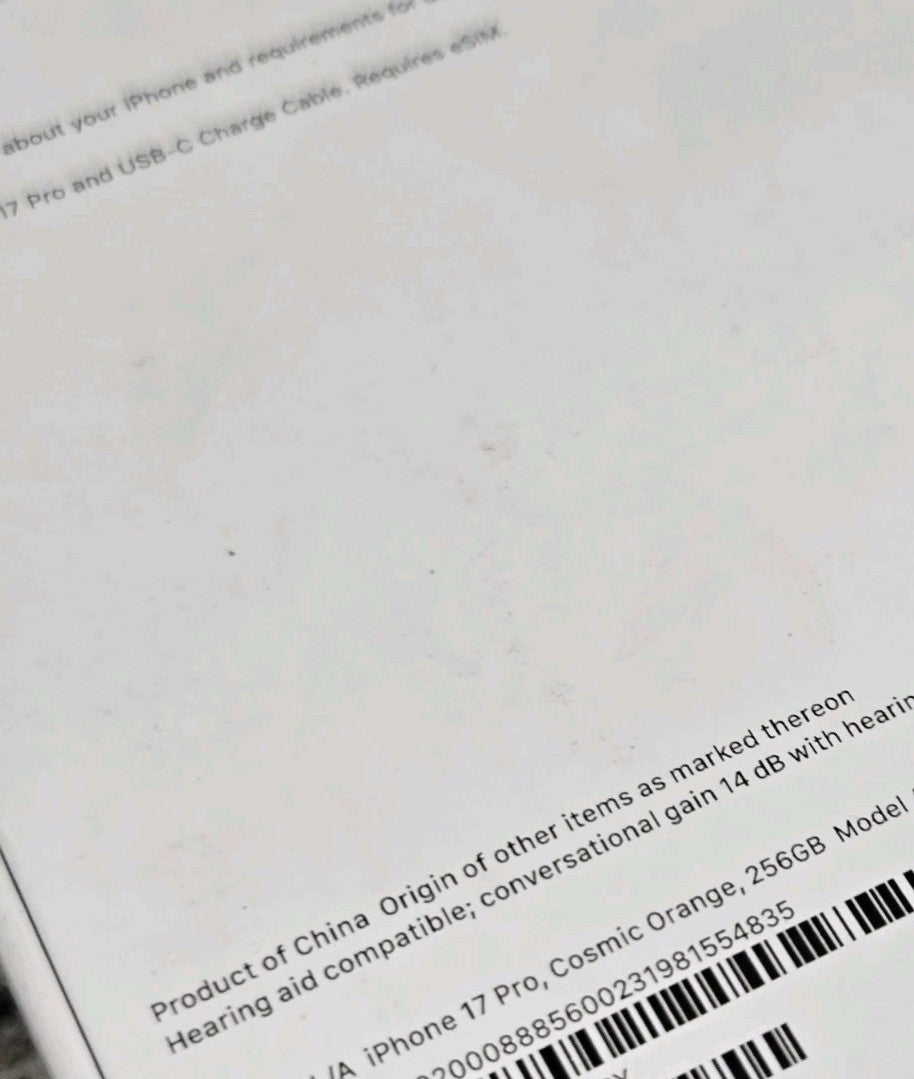 Apple iPhone 17 Pro Cosmic Orange 256GB box label showing product details and barcode close-up view