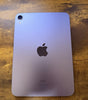 Purple Apple iPad Mini 6th Gen A2567 showing back with single camera and Apple logo on wooden surface
